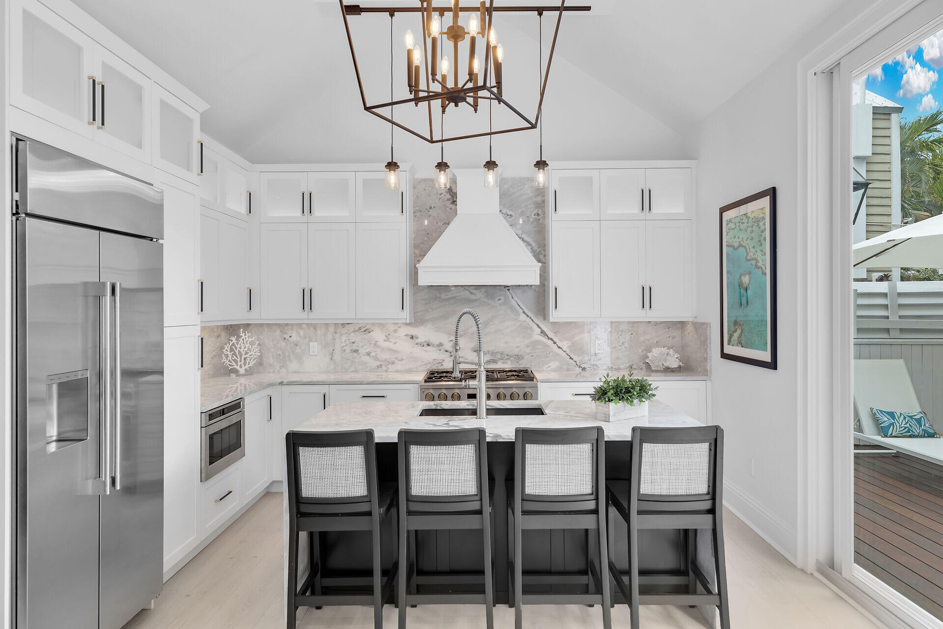 1015 Eaton Street Key West, FL 33040 - Photo 23 of 36 a kitchen with stainless steel appliances a dining table chairs and granite counter tops