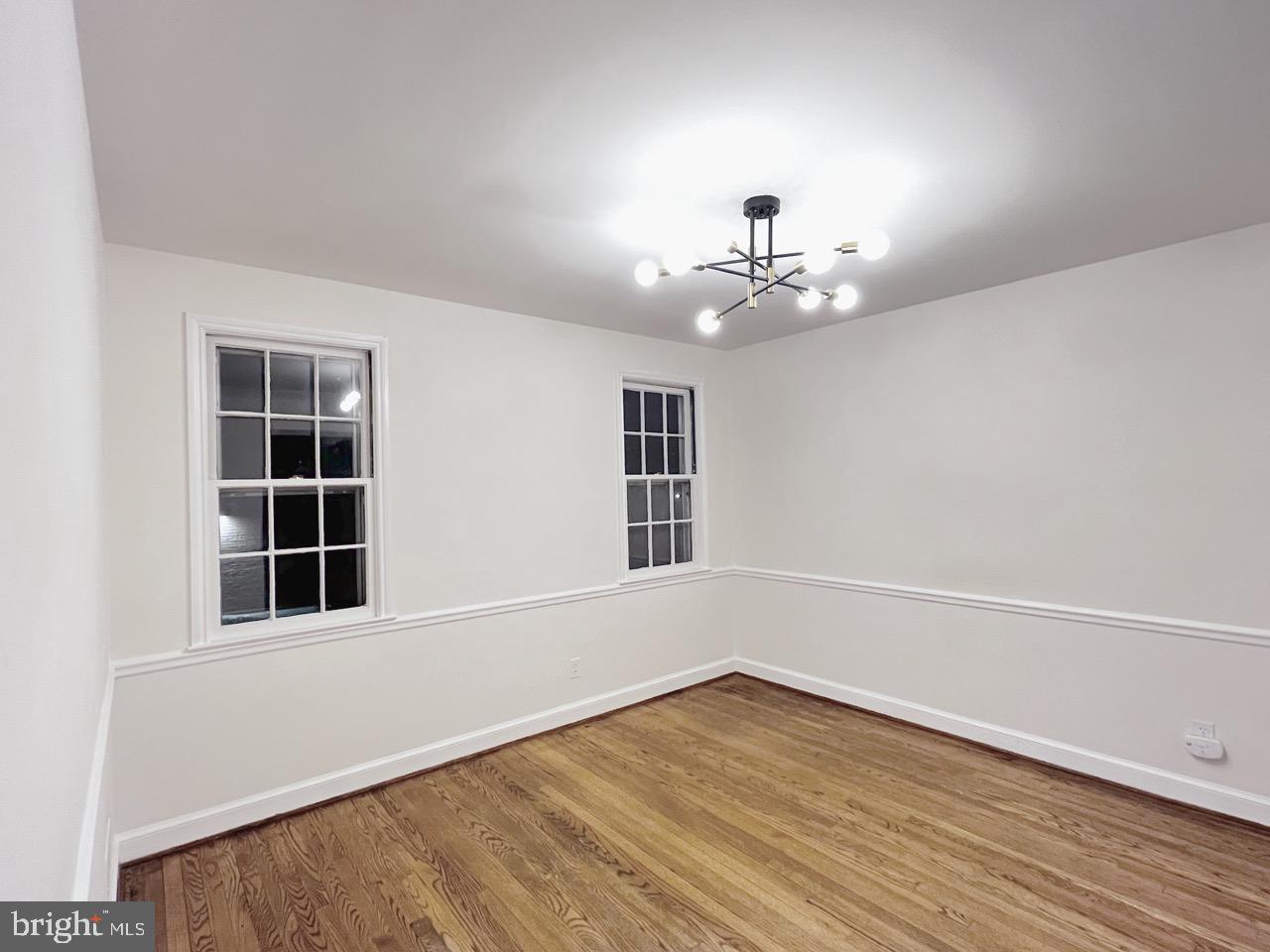 5507 Chesterbrook Road Bethesda, MD 20816 - Photo 12 of 24 wooden floor in an empty room with a window