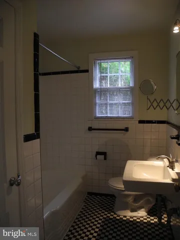 a bathroom with a toilet a sink and window