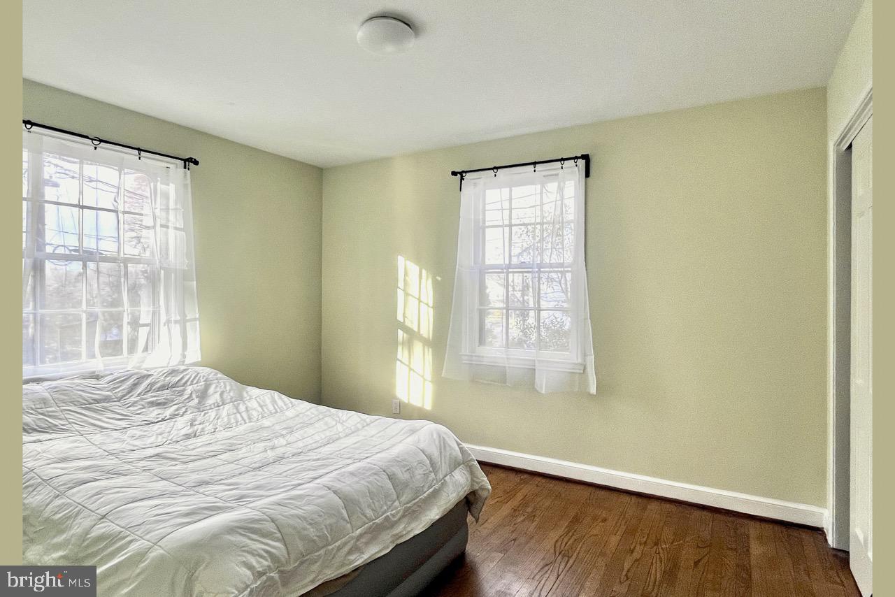 5507 Chesterbrook Road Bethesda, MD 20816 - Photo 14 of 24 a bedroom with a bed and wooden floor