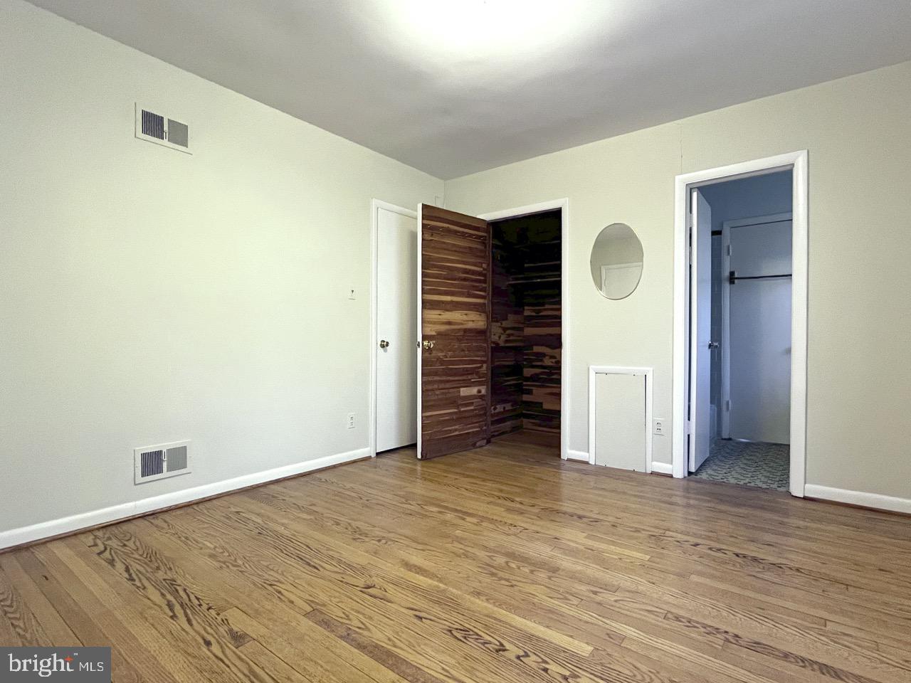 5507 Chesterbrook Road Bethesda, MD 20816 - Photo 15 of 24 a view of an empty room with wooden floor and closet