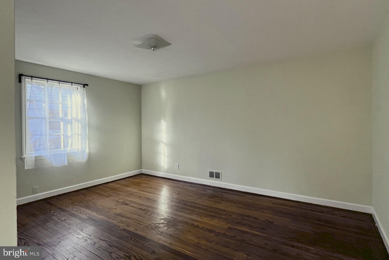 5507 Chesterbrook Road Bethesda, MD 20816 - Photo 16 of 24 an empty room with wooden floor and windows