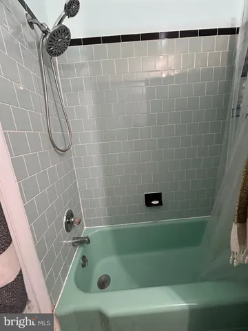 a bathroom with a shower and a bathtub