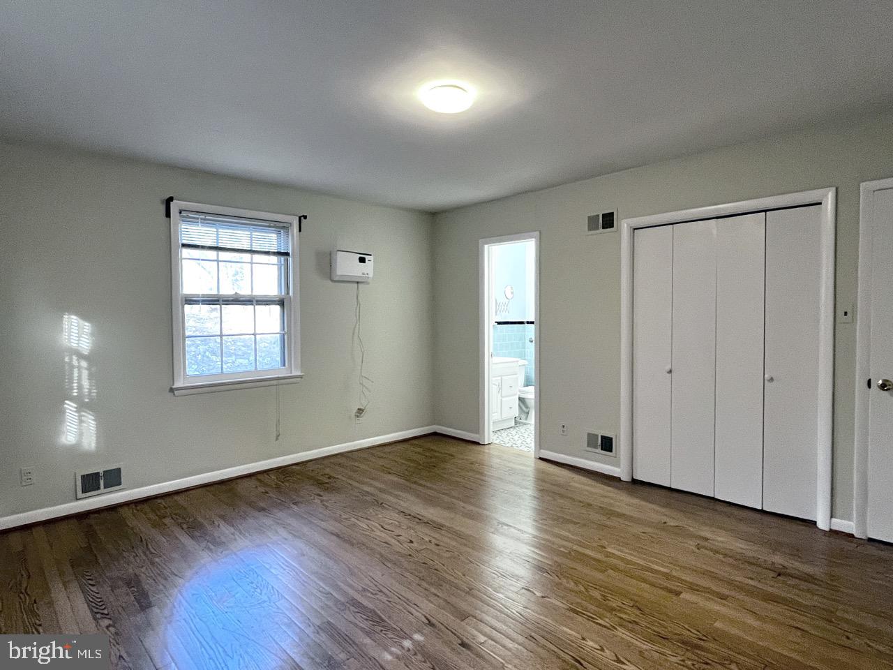 5507 Chesterbrook Road Bethesda, MD 20816 - Photo 17 of 24 an empty room with wooden floor and windows