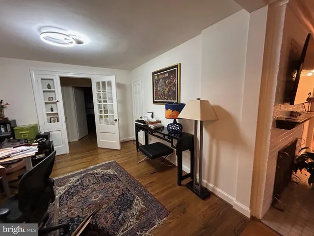 a living room with furniture rug and a flat screen tv