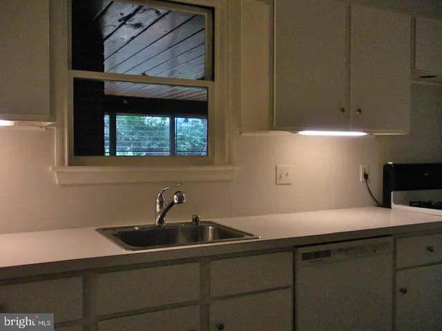 a kitchen with a sink and cabinets