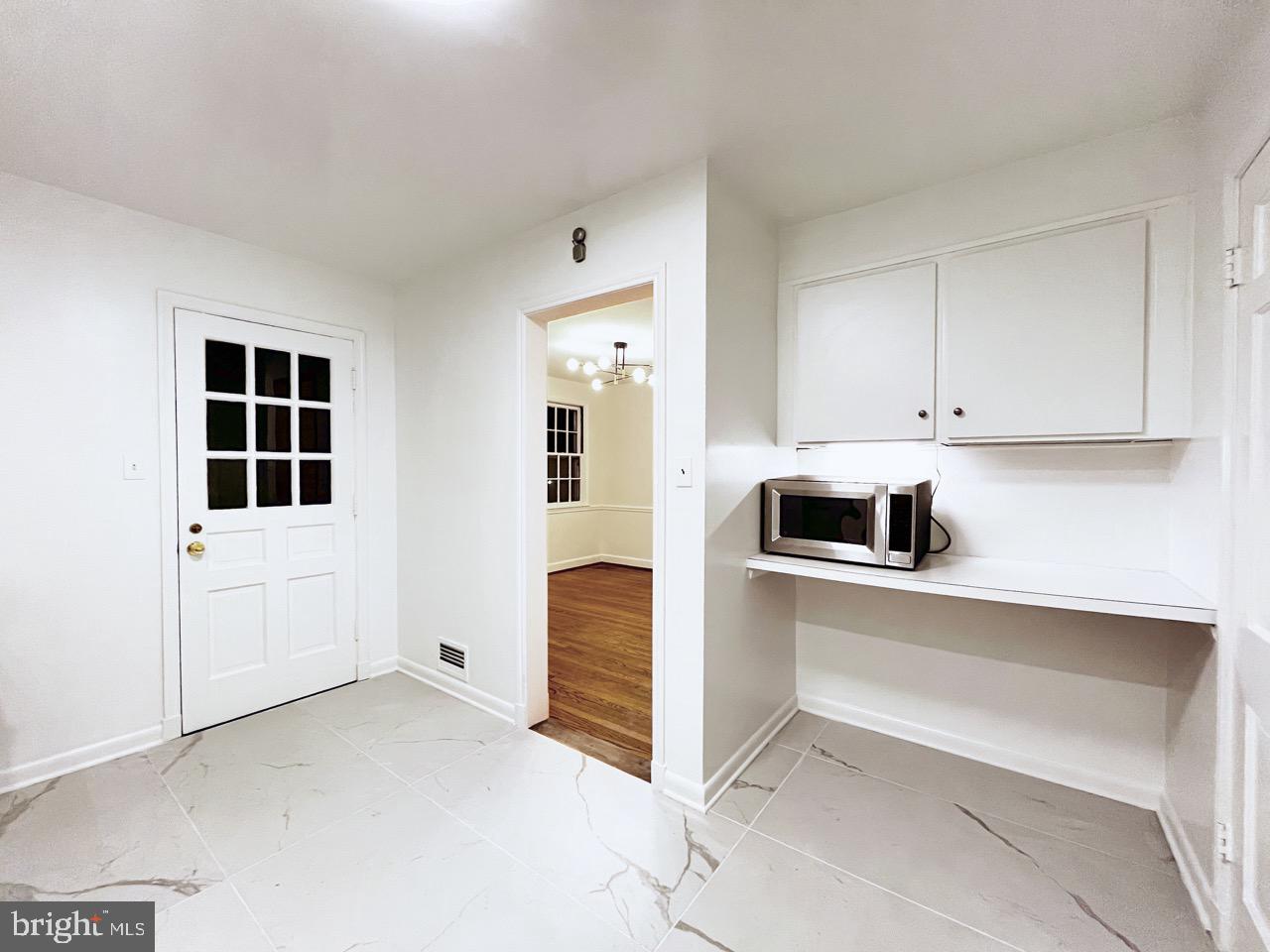 5507 Chesterbrook Road Bethesda, MD 20816 - Photo 6 of 24 a kitchen with stainless steel appliances a refrigerator and a stove top oven