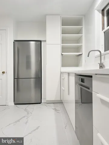a kitchen with a refrigerator and a sink