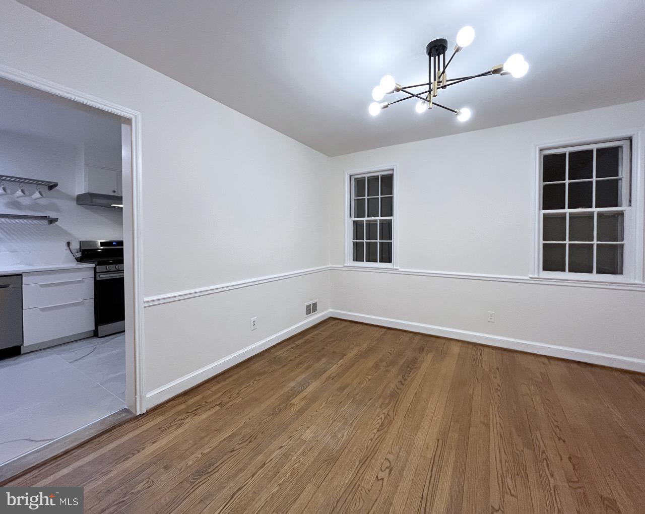5507 Chesterbrook Road Bethesda, MD 20816 - Photo 9 of 24 wooden floor in an empty room with a window