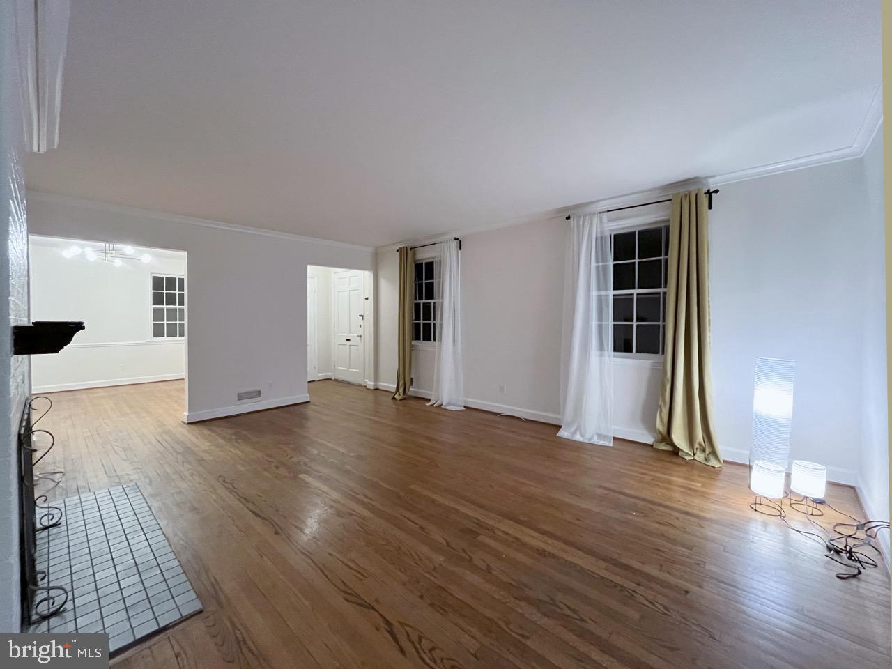 5507 Chesterbrook Road Bethesda, MD 20816 - Photo 10 of 24 an empty room with wooden floor and windows