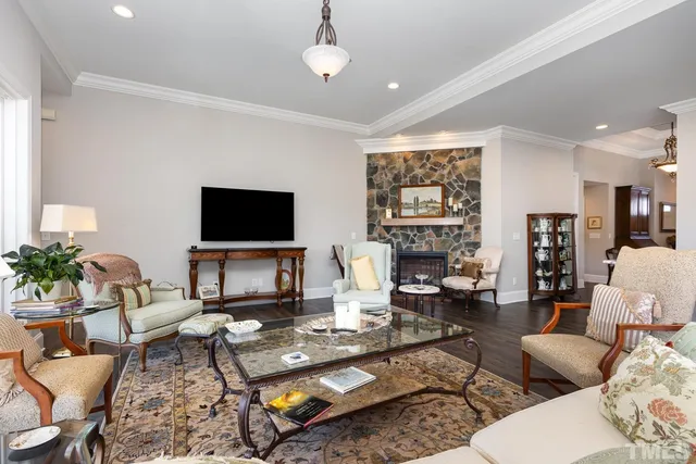 a living room with furniture a large window and a flat screen tv