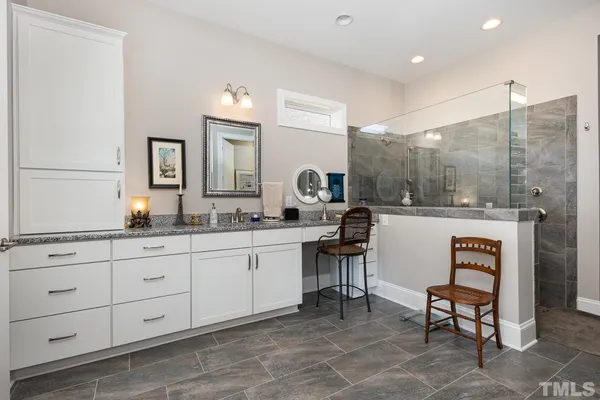 a spacious bathroom with a double vanity sink and a mirror