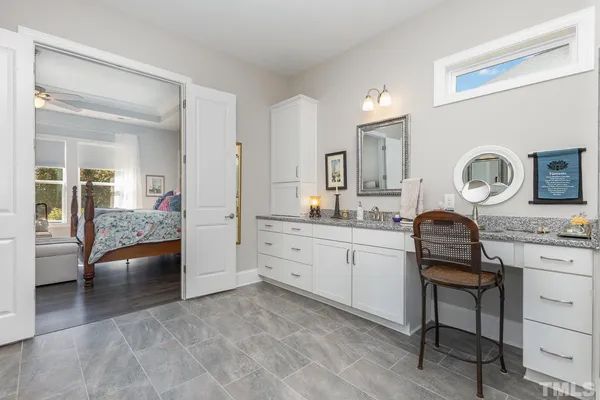 a kitchen with a stove and white cabinets