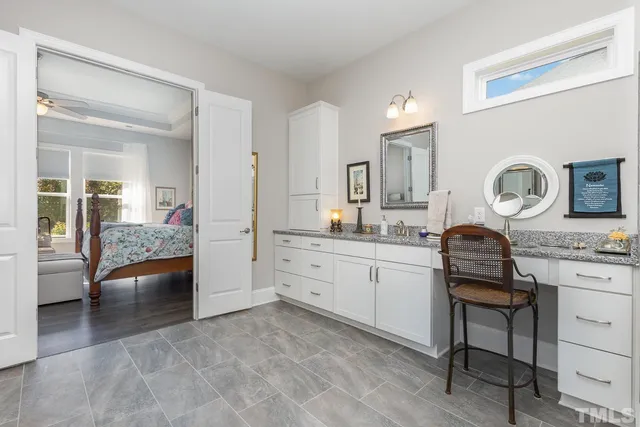 a kitchen with a stove and white cabinets