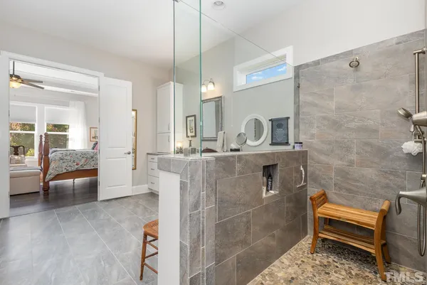 a bathroom with a double vanity sink a mirror and a bathtub