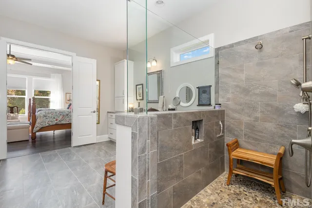 a bathroom with a double vanity sink a mirror and a bathtub