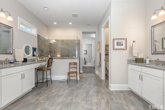 a large bathroom with double vanity and a mirror