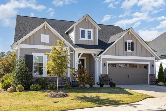 a view of a house with a swimming pool and a yard