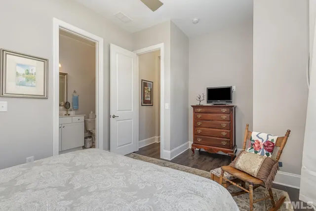 a bedroom with a bed and a television