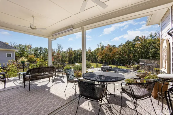 a view of a patio with a dining table and chairs