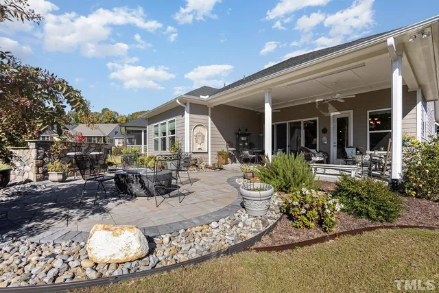a view of a patio with couches table and chairs and potted plants