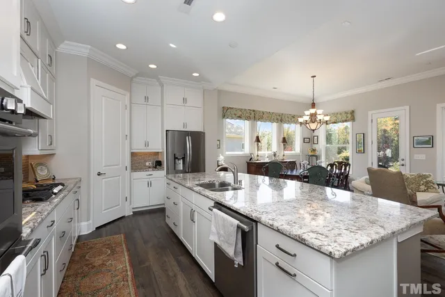 a large white kitchen with a stove and a sink