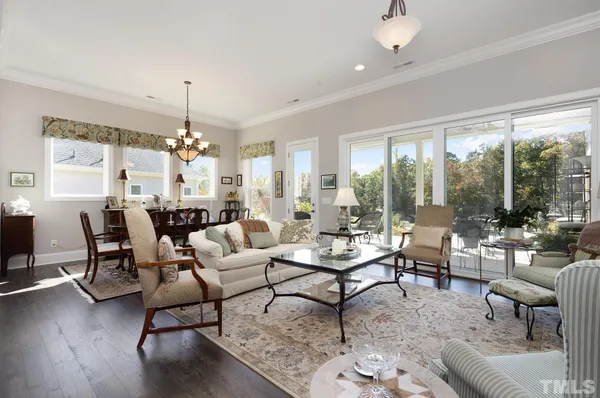 a living room with furniture and a chandelier