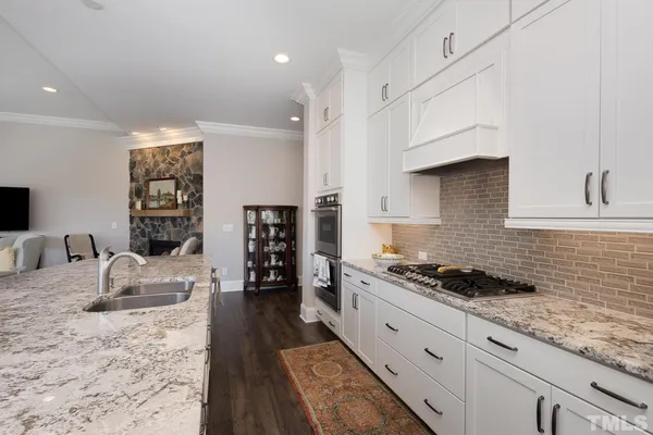 a kitchen with stainless steel appliances granite countertop a stove and a sink