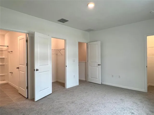 a bathroom with a double vanity sink toilet and shower