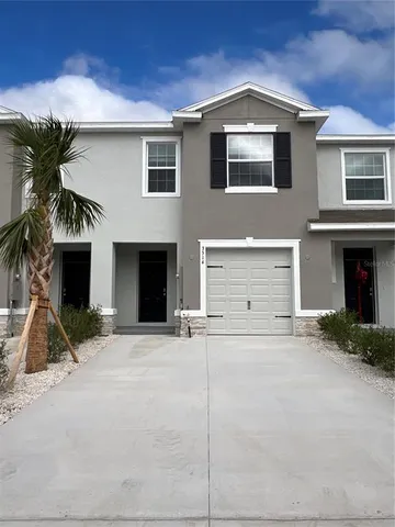 a front view of a house with a yard and garage
