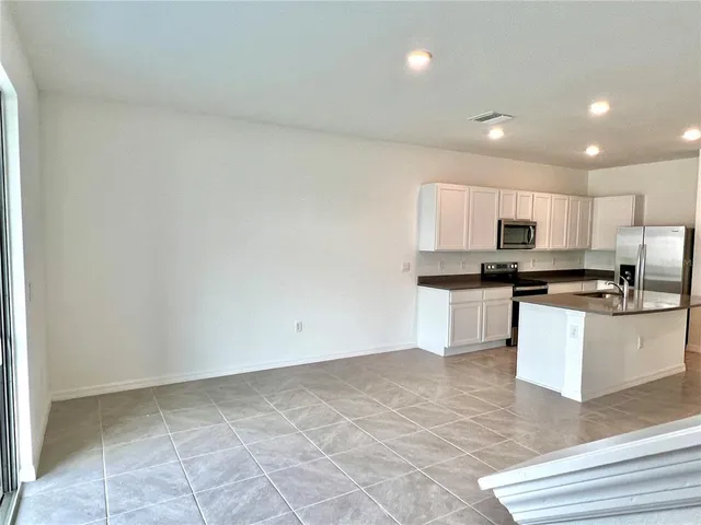 a kitchen with stainless steel appliances granite countertop a sink and a stove top oven
