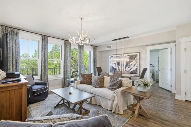 a living room with furniture and a chandelier