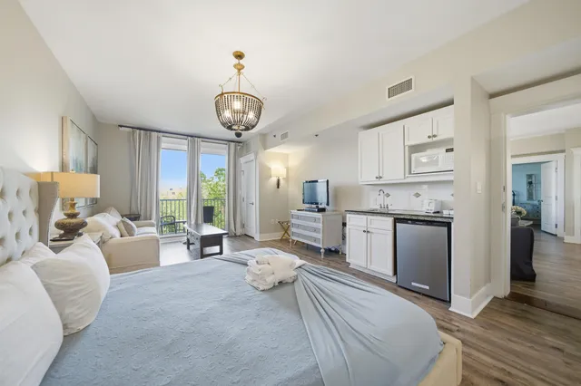 a living room with furniture and kitchen view
