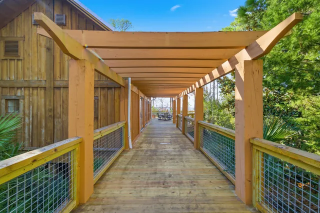 a view of balcony with wooden floor and fence