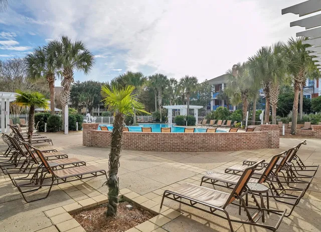 a street sign on a sidewalk next to a road