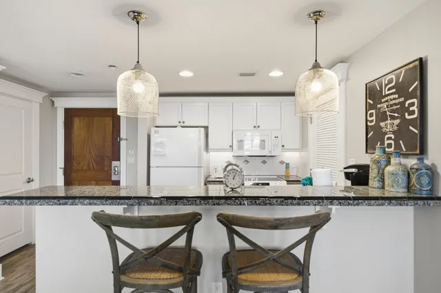 a kitchen with a counter space a sink appliances and cabinets