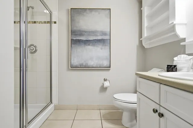 a bathroom with a toilet sink and shower