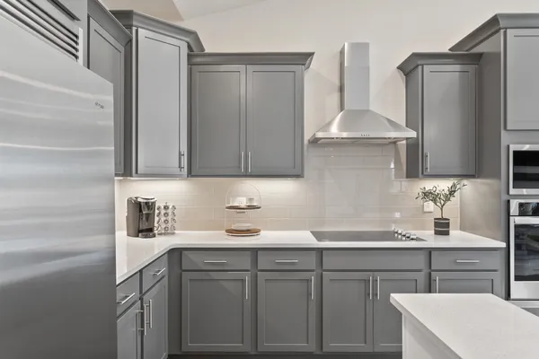 a kitchen with a sink a stove and cabinets
