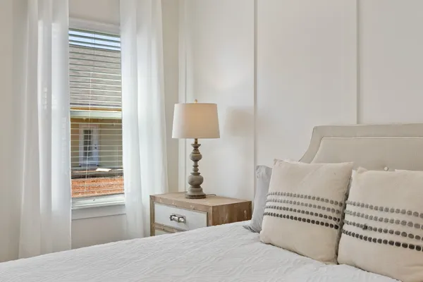 a bedroom with a bed and a window