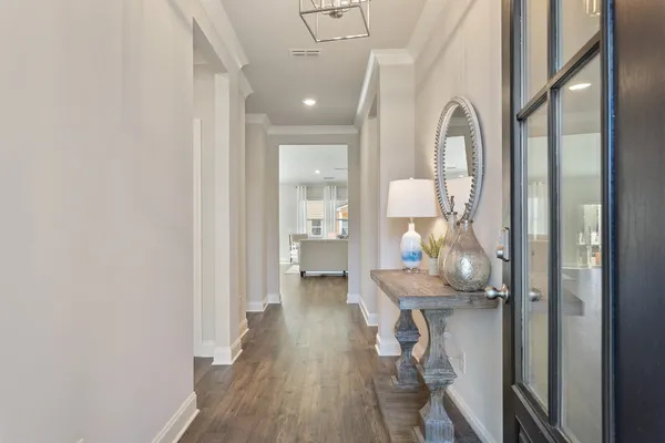 a view of a hallway with wooden floor fireplace and living room