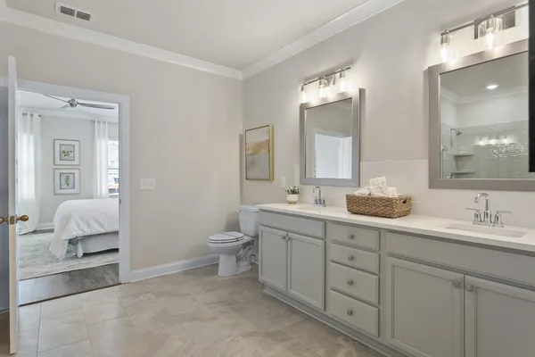 a bathroom with a sink a toilet and a mirror