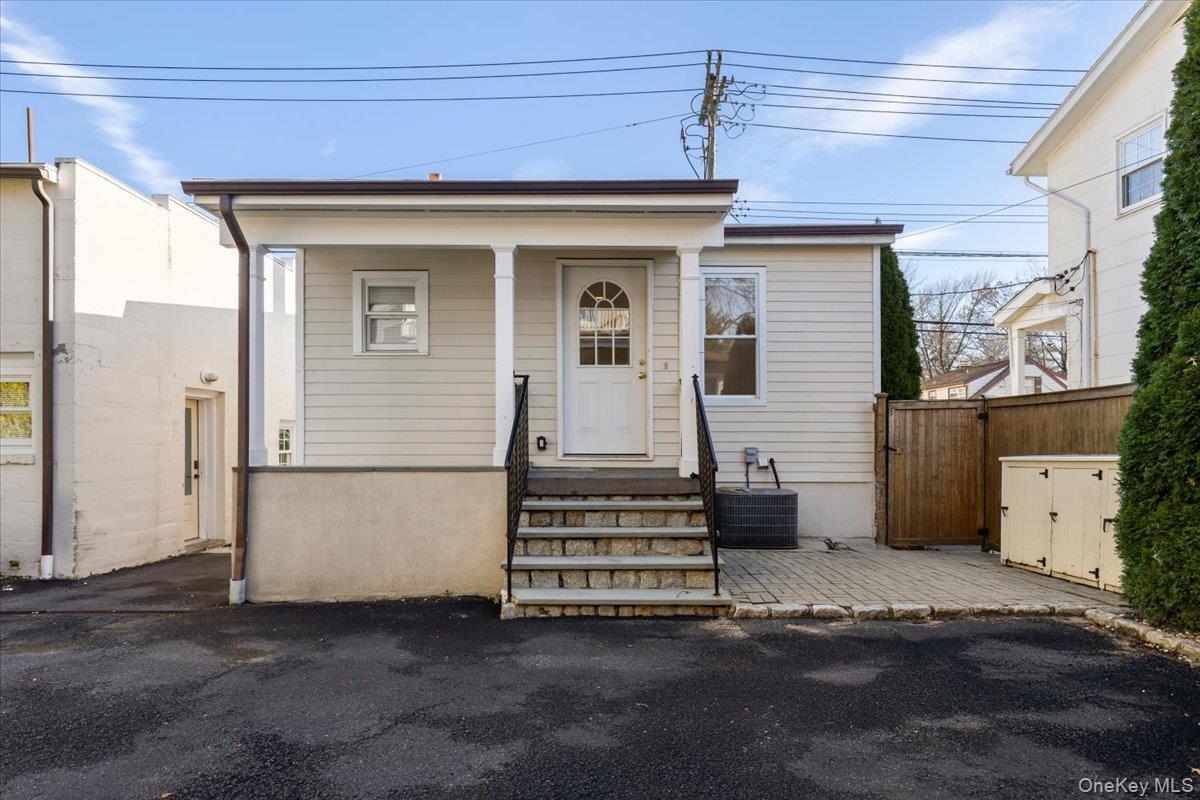 397 Midland Avenue, Unit 397 Rye, NY 10580 - Photo 2 of 16 a view of a house with a barbeque and wooden stairs