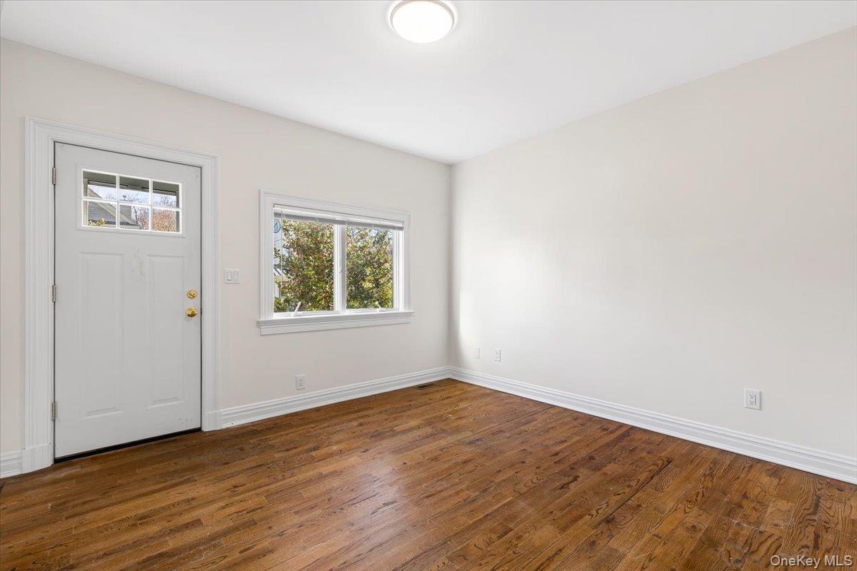 397 Midland Avenue, Unit 397 Rye, NY 10580 - Photo 3 of 16 an empty room with wooden floor and windows
