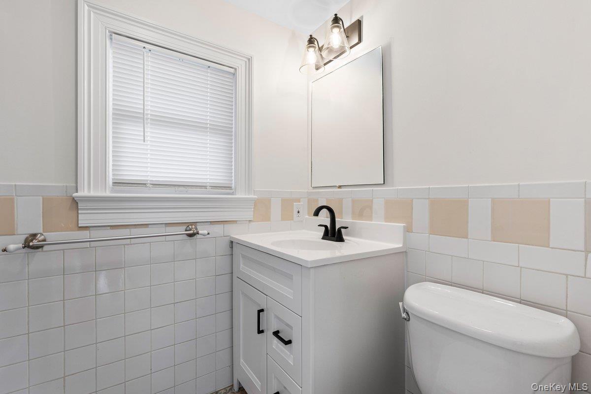 397 Midland Avenue, Unit 397 Rye, NY 10580 - Photo 7 of 16 a bathroom with a sink a toilet and a mirror
