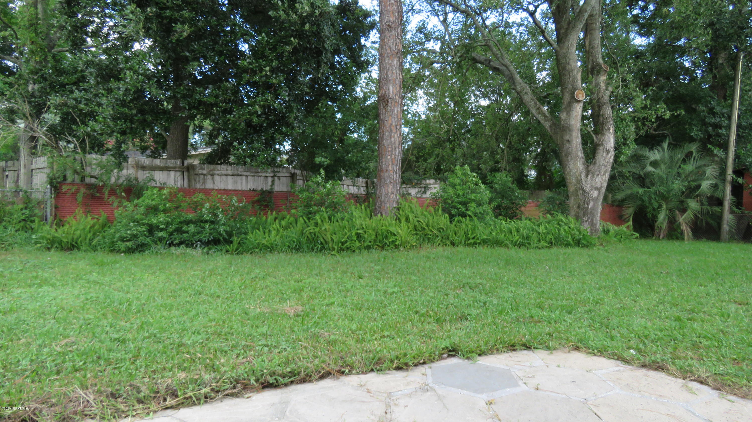 4715 Spring Park Road Jacksonville, FL 32207 - Photo 6 of 12 a view of a garden with plants and large trees