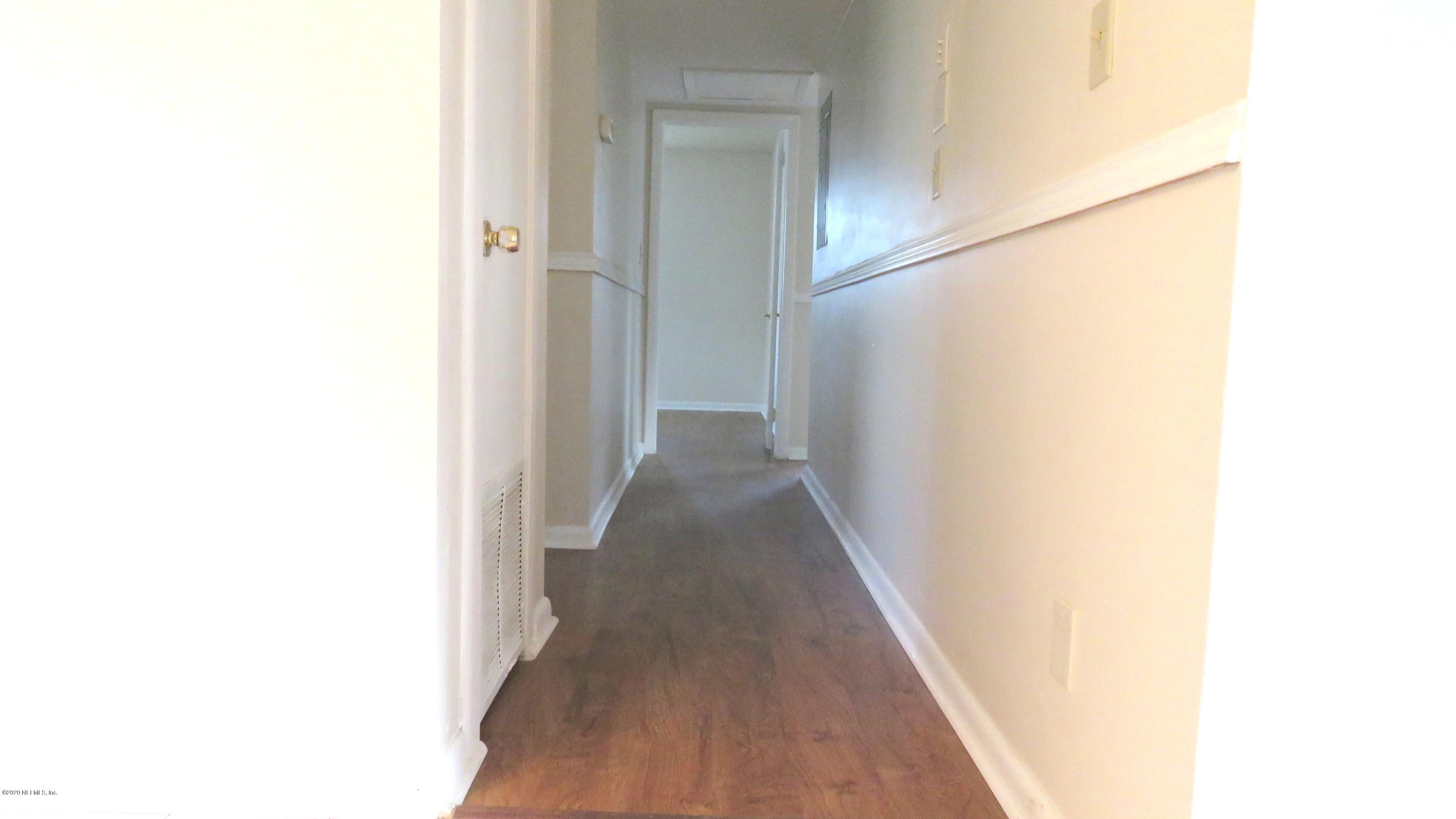 4715 Spring Park Road Jacksonville, FL 32207 - Photo 7 of 12 a view of a hallway with wooden floor