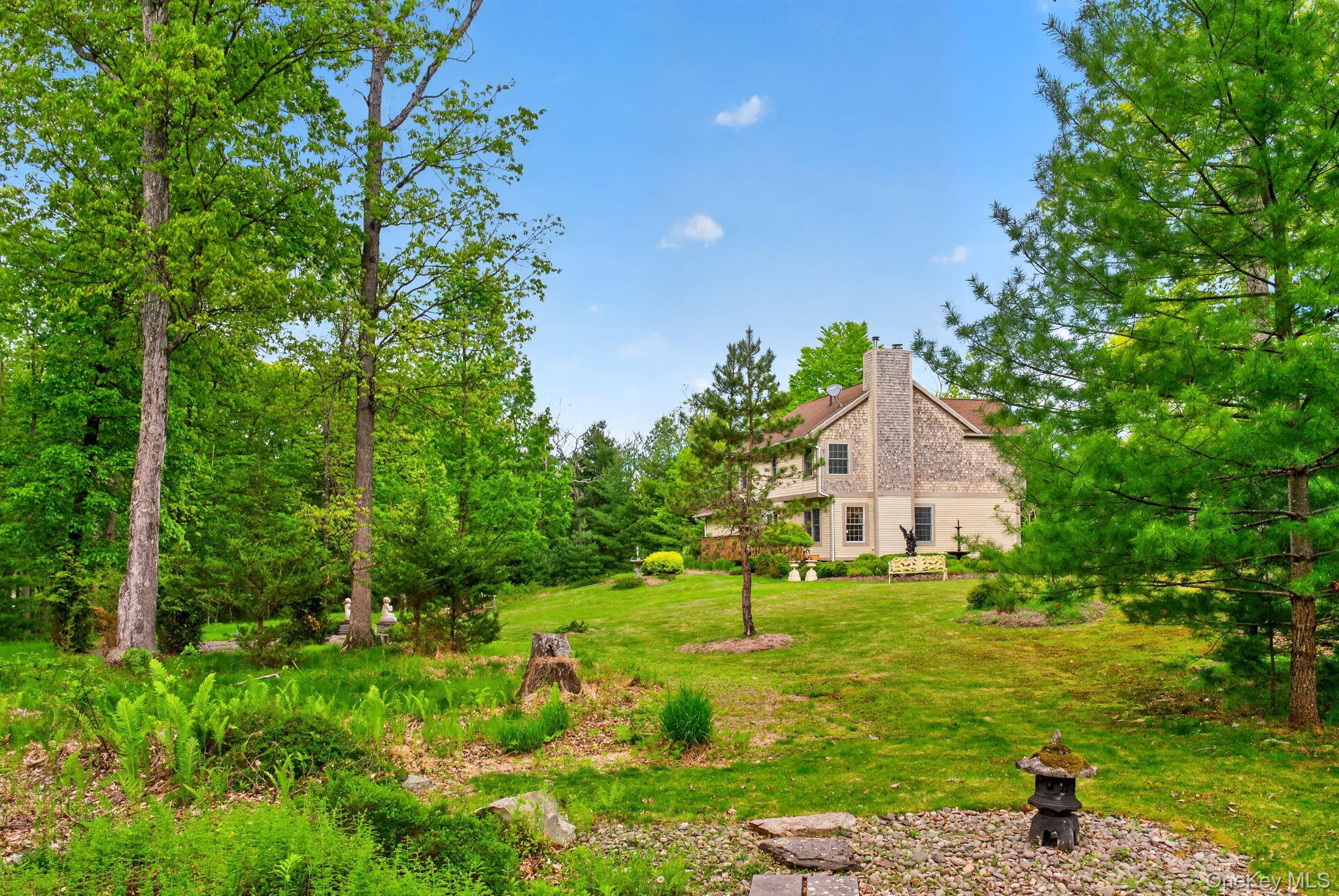189 Bush Road Stone Ridge, NY 12484 - Photo 47 of 49 a view of a garden with a house in the background