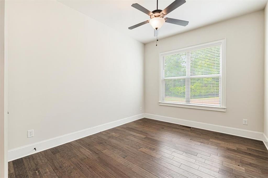 947 Hunter Way Milton, GA 30004 - Photo 39 of 78 an empty room with wooden floor fan and windows