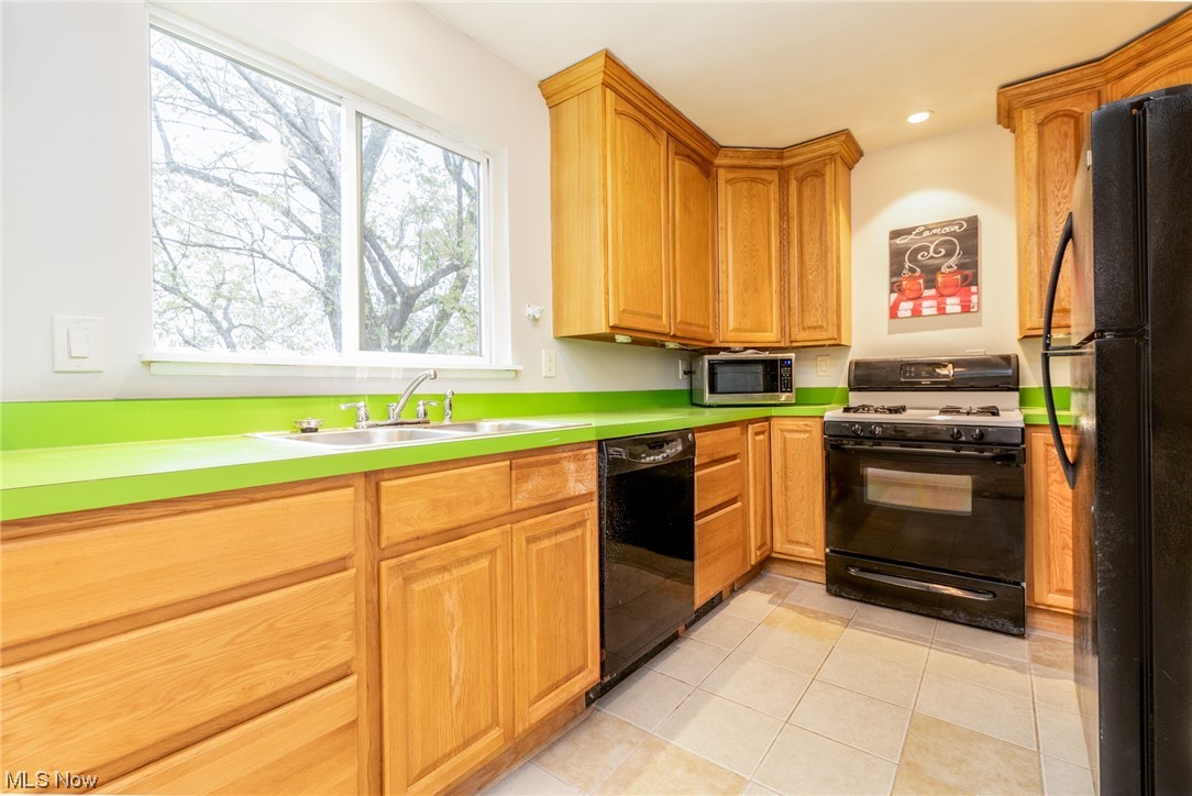 4534 Grayton Road Cleveland, OH 44135 - Photo 13 of 25 Kitchen has wood cabinetry, ceramic tile flooring and all appliances