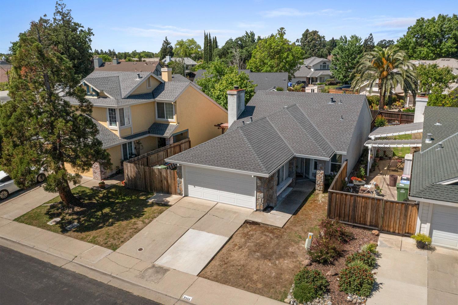 an aerial view of a house with a yard